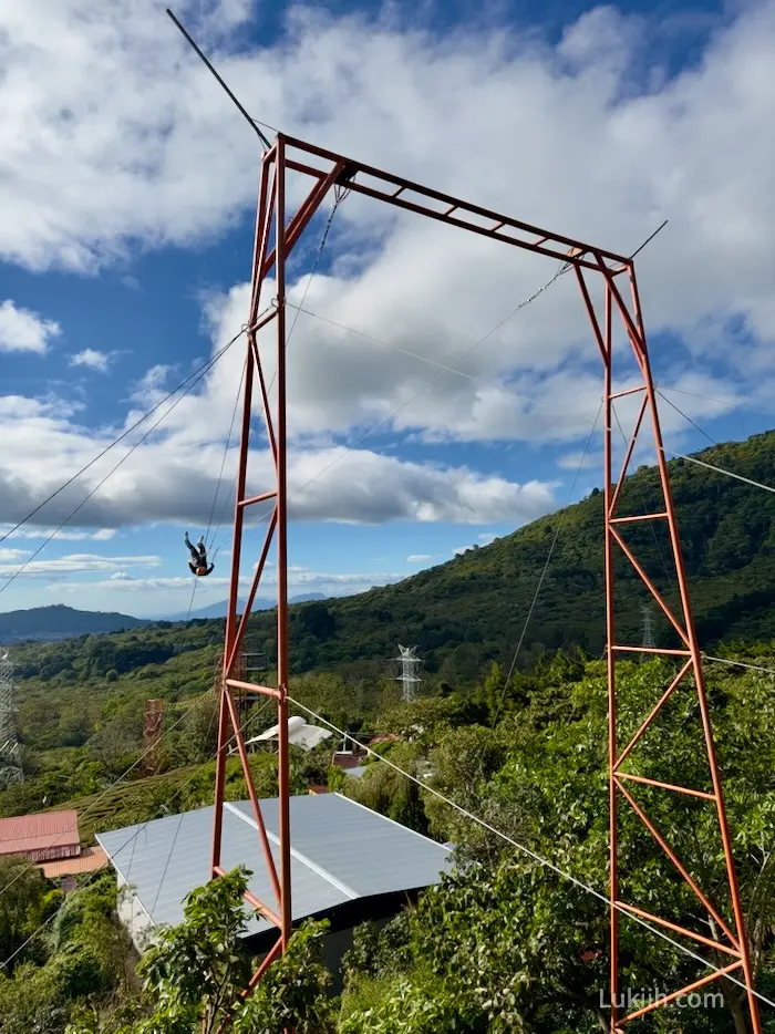 A person swinging on a very big swing.