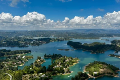 A view of a pristine lake with lush hills.