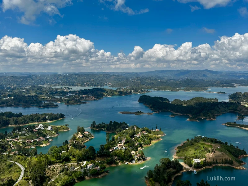 A view of a pristine lake with lush hills.