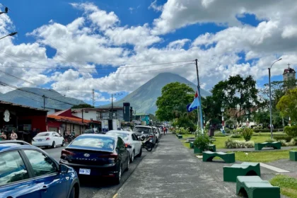 A tropical town with a towering volcano.