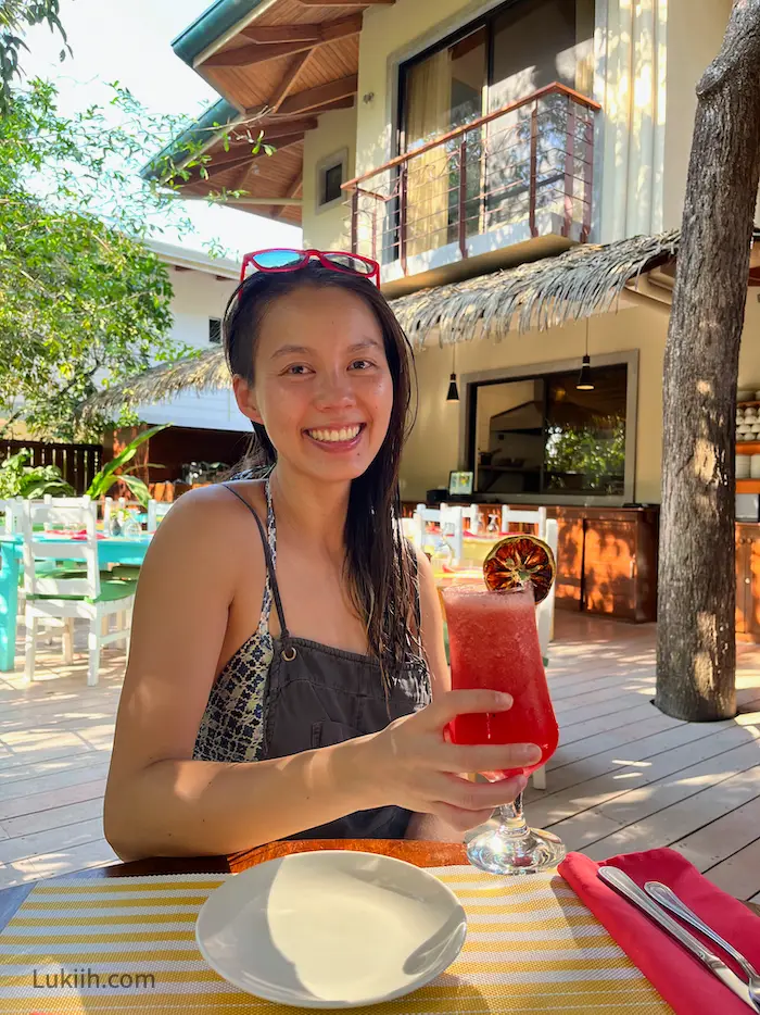 A woman drinking a fresh watermelon juice.