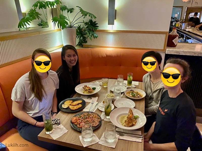 Four people enjoying a fancy-looking meal.