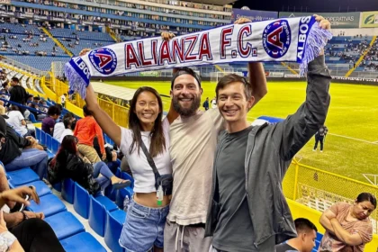 Three people holding a banner that says ALIANZA FC.