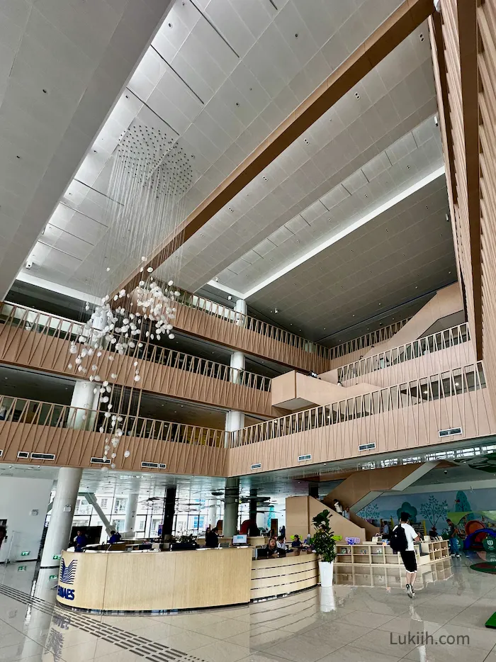 The interior of a modern library with several floors.