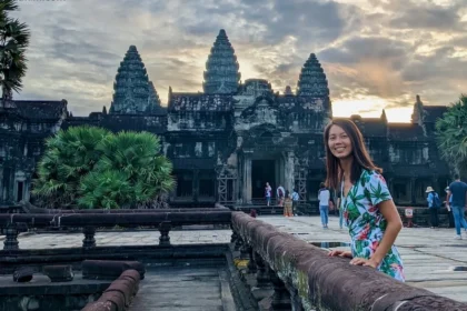 A woman with an ancient building with three beaks in the background.