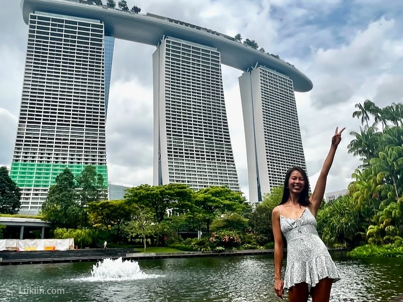 A woman standing next to a modern building.