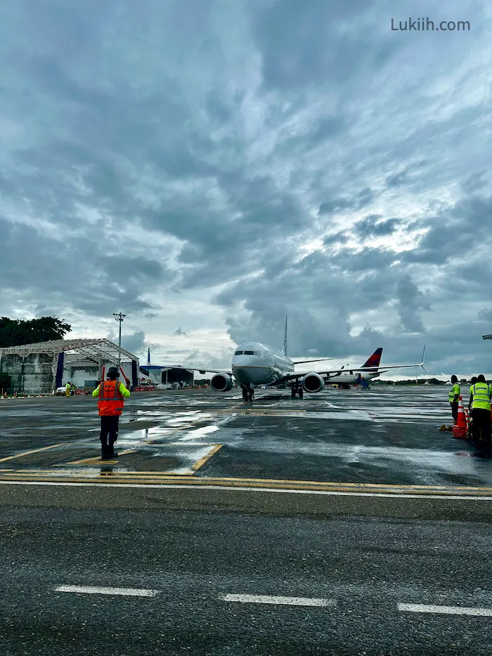 An airplane on an empty and open runway.