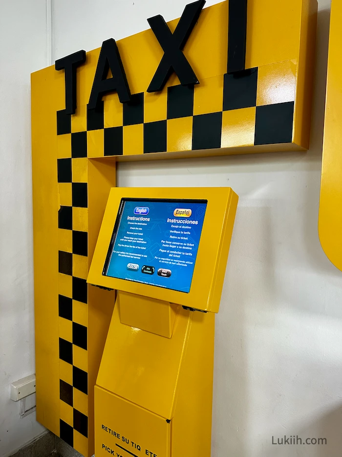 A yellow kiosk that says TAXI.