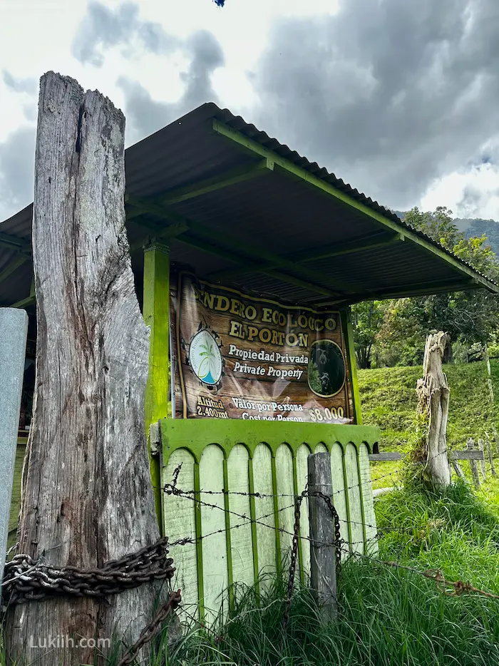 A simple hut in a mountain area with entrance fee on it.