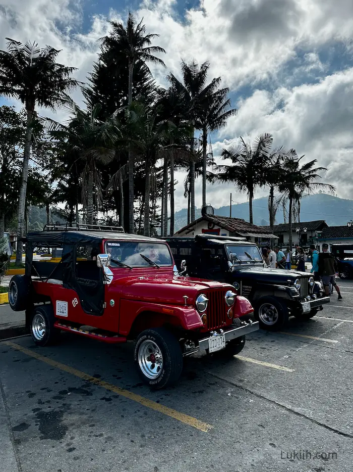 A set of Jeeps parked in a parking lot.