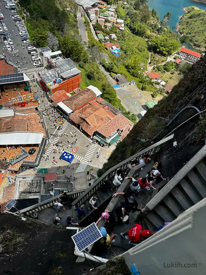 A photo taken from above, looking down at zig zagging stairs embedded onto a rock.