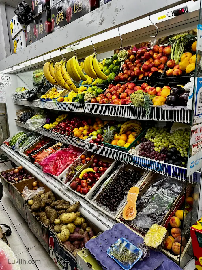 An indoor market with lots of different tropical fruits.