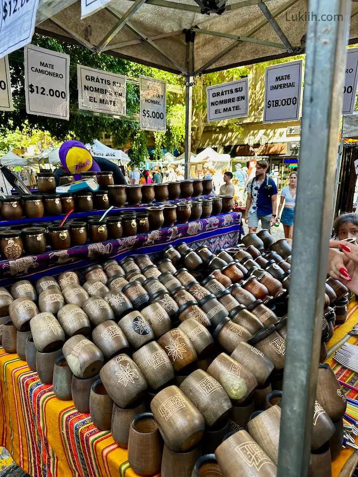 Wooden cups being sold at an open-air market.