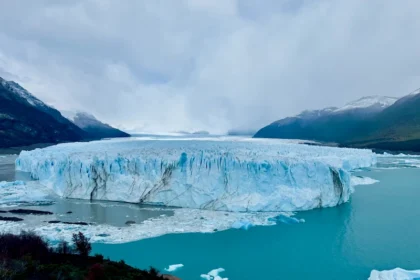 A massive blue glacier with impressive patterns.