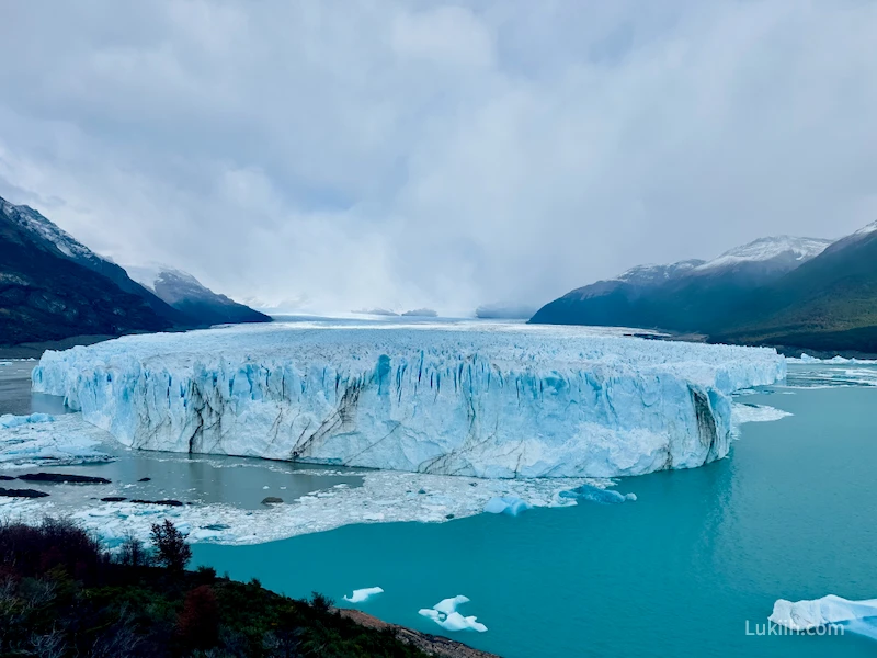 A massive blue glacier with impressive patterns.